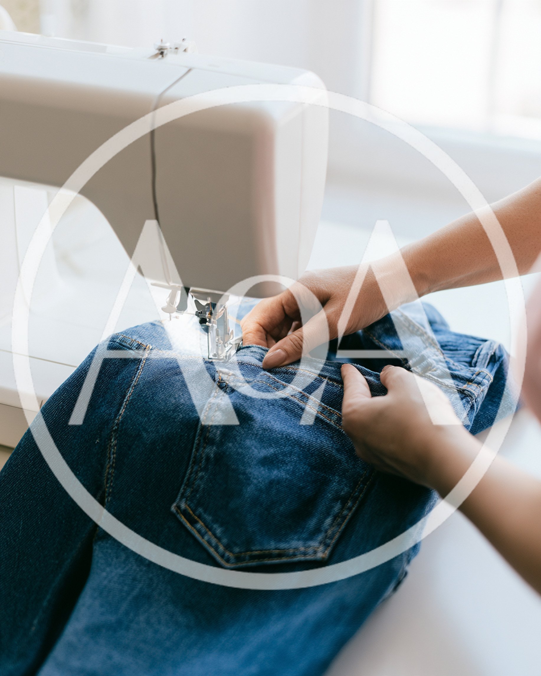 Person Sewing Denim Jeans On A Sewing Machine