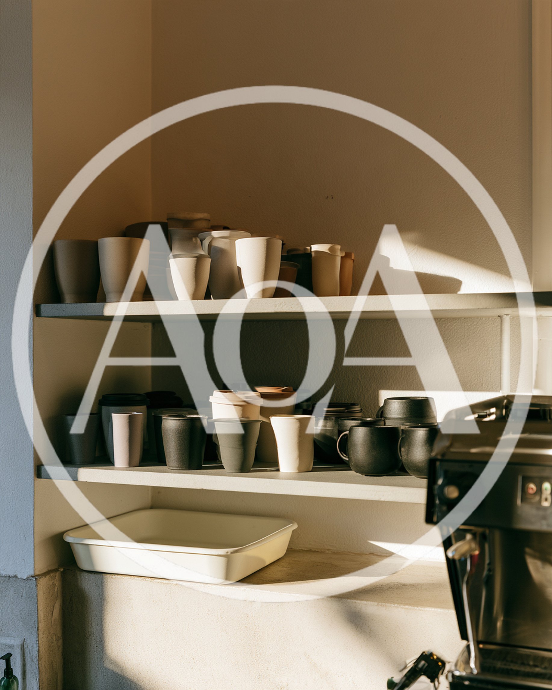 Ceramic Coffee Cups Arranged On Cafe Shelves