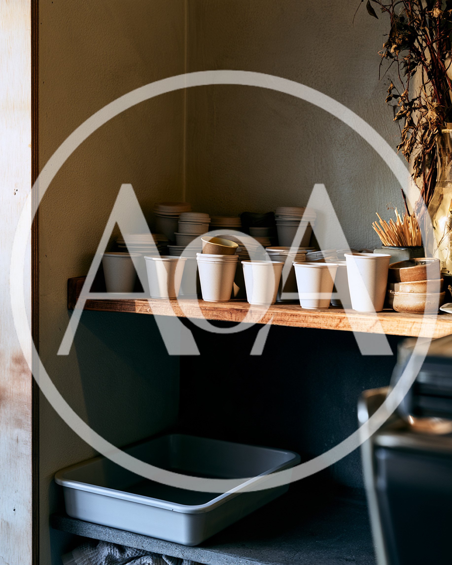 Stacked Paper Coffee Cups on a Wooden Shelf