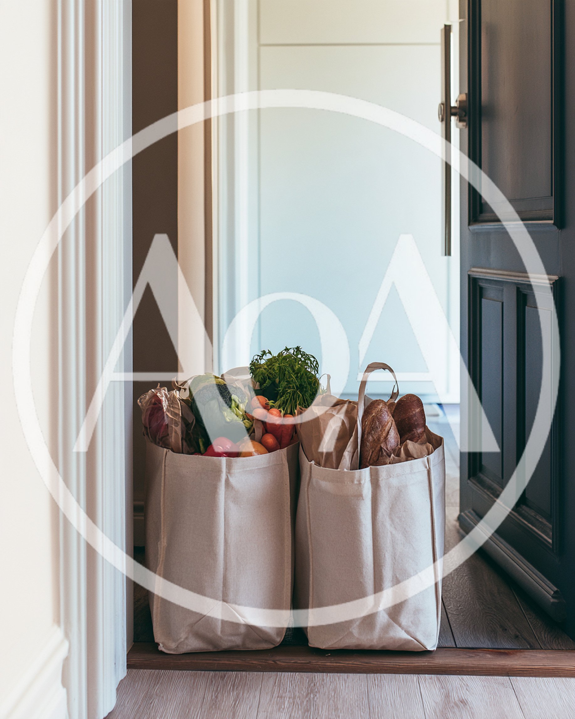 Two Canvas Grocery Bags Filled With Fresh Produce And Bread
