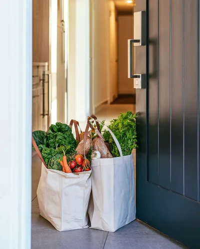 Two Canvas Grocery Bags Filled With Fresh Produce