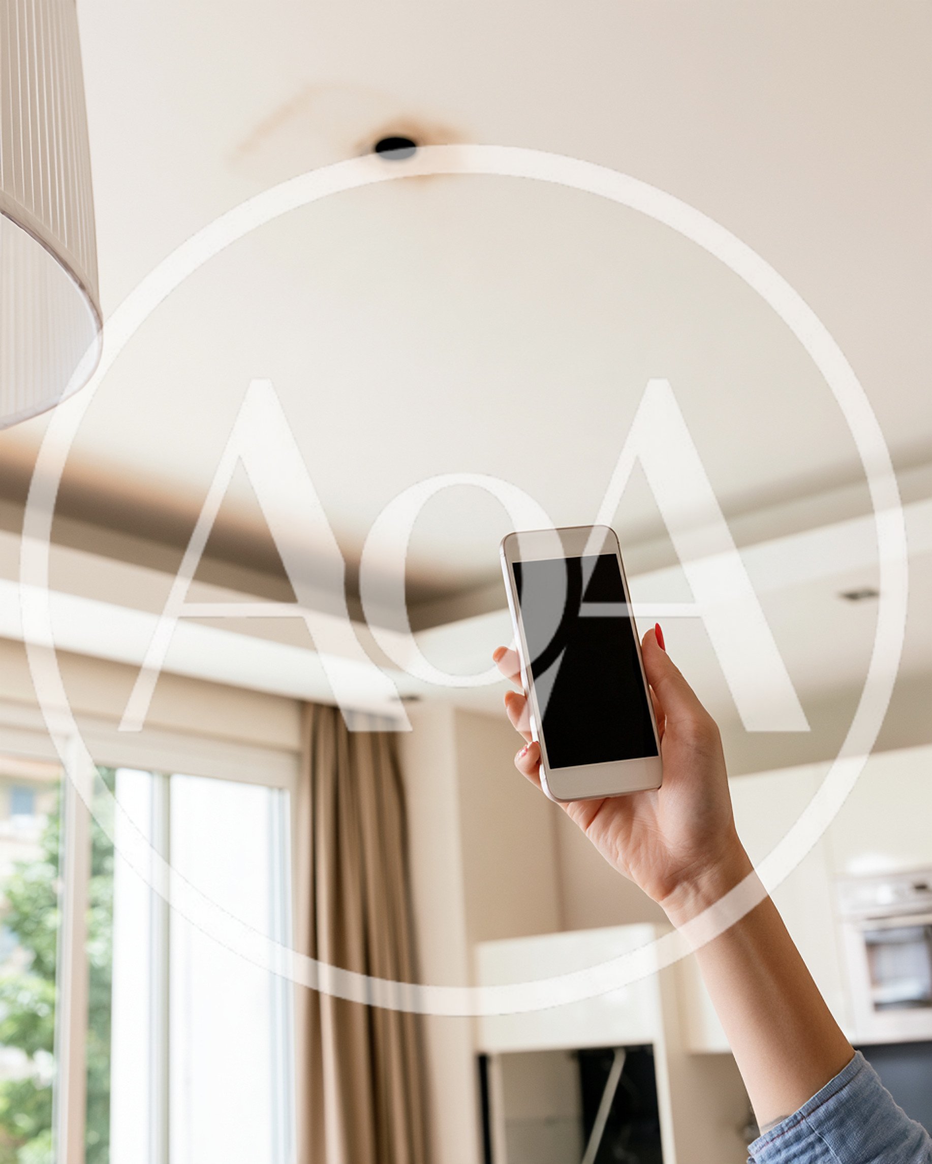 Person Holding Smartphone Towards Ceiling Light Fixture