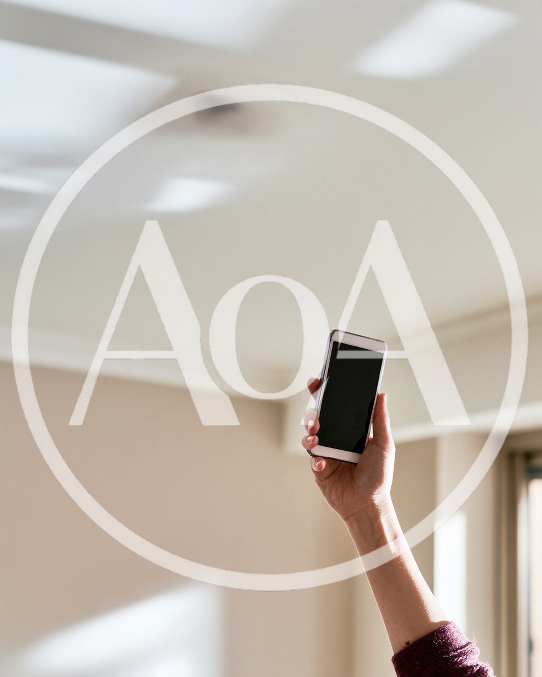 Hand Holding Smartphone Upwards In Bright Room