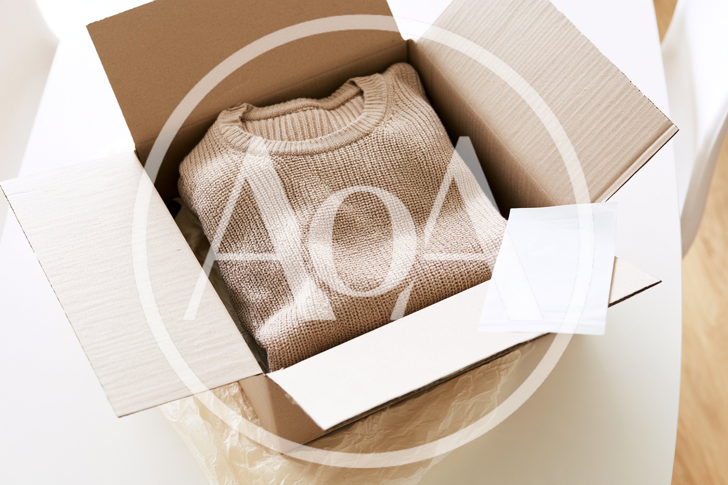 Beige Knitted Sweater Inside A Cardboard Shipping Box