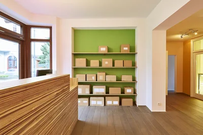 Cardboard Shipping Boxes Arranged On Shelves In Office