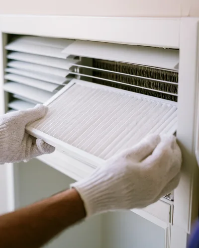 Technician Replacing Air Conditioner Filter