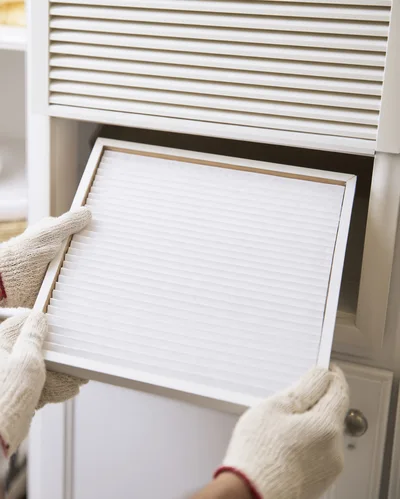 Person Replacing Air Filter In Home HVAC System