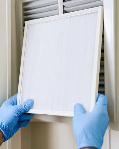 Technician Replacing Air Conditioner Filter