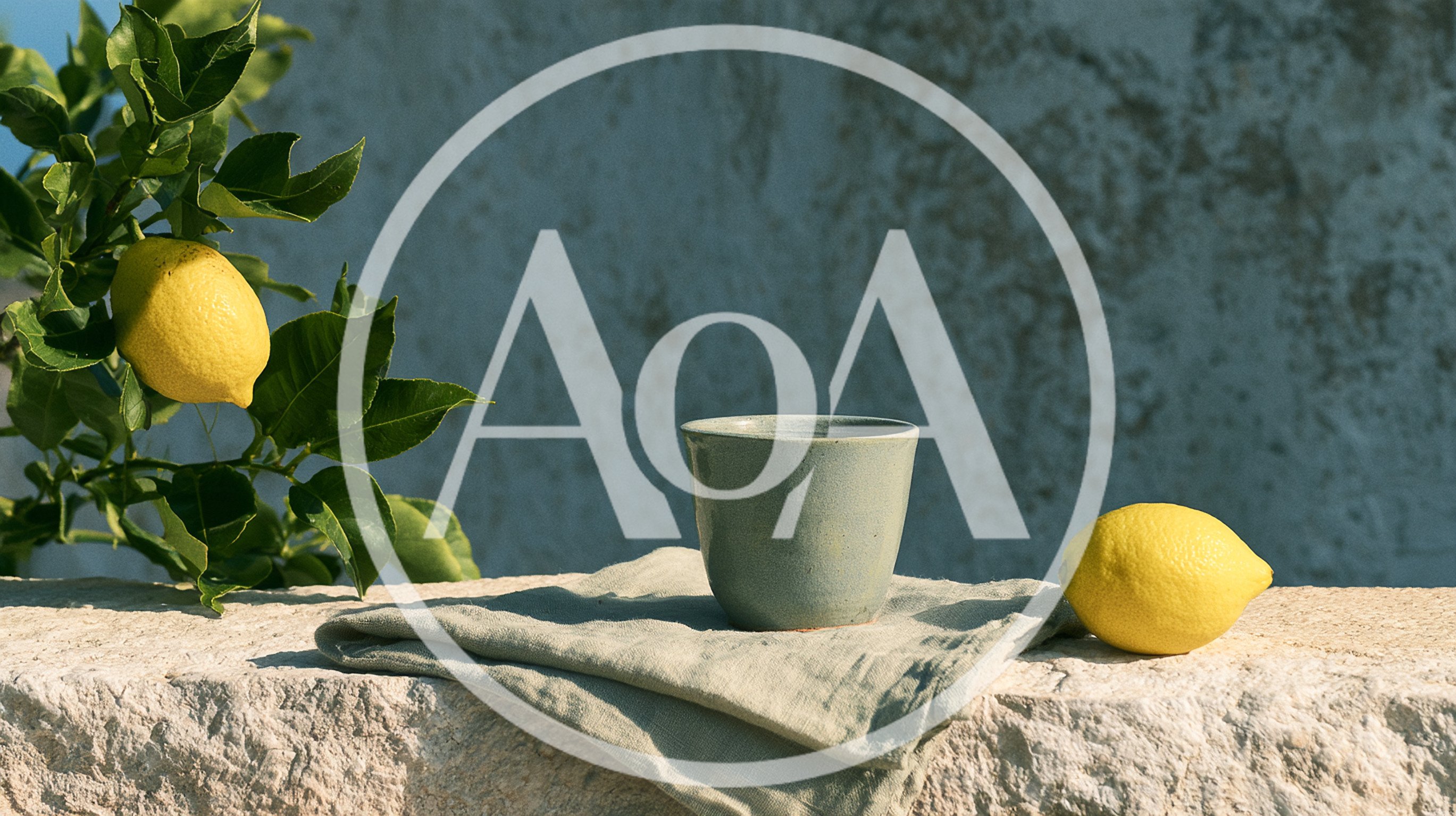 Ceramic Cup And Fresh Lemons On A Stone Wall