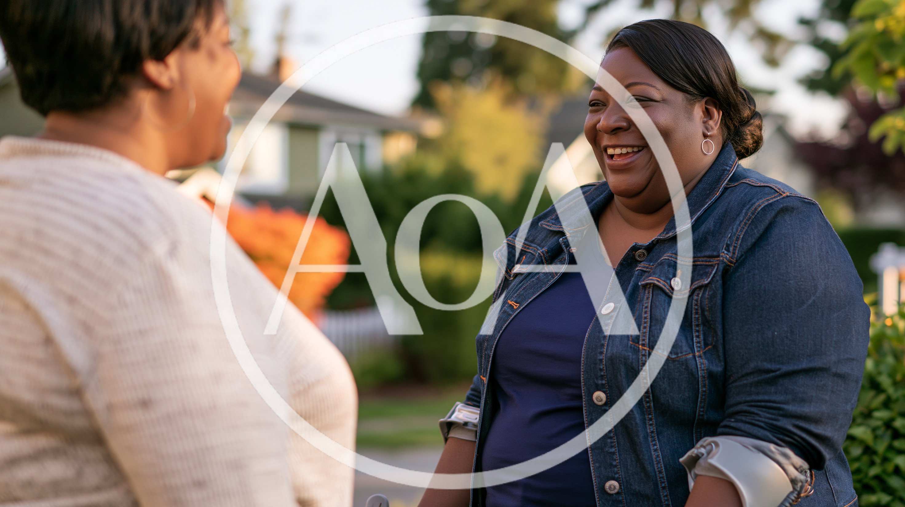 Two Women Laughing Together Outdoors In A Neighborhood