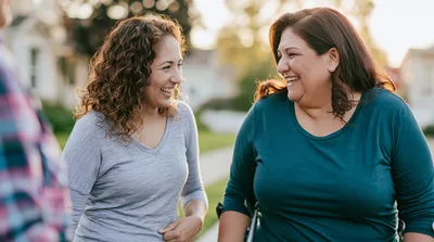 Two Women Laughing Together Outdoors