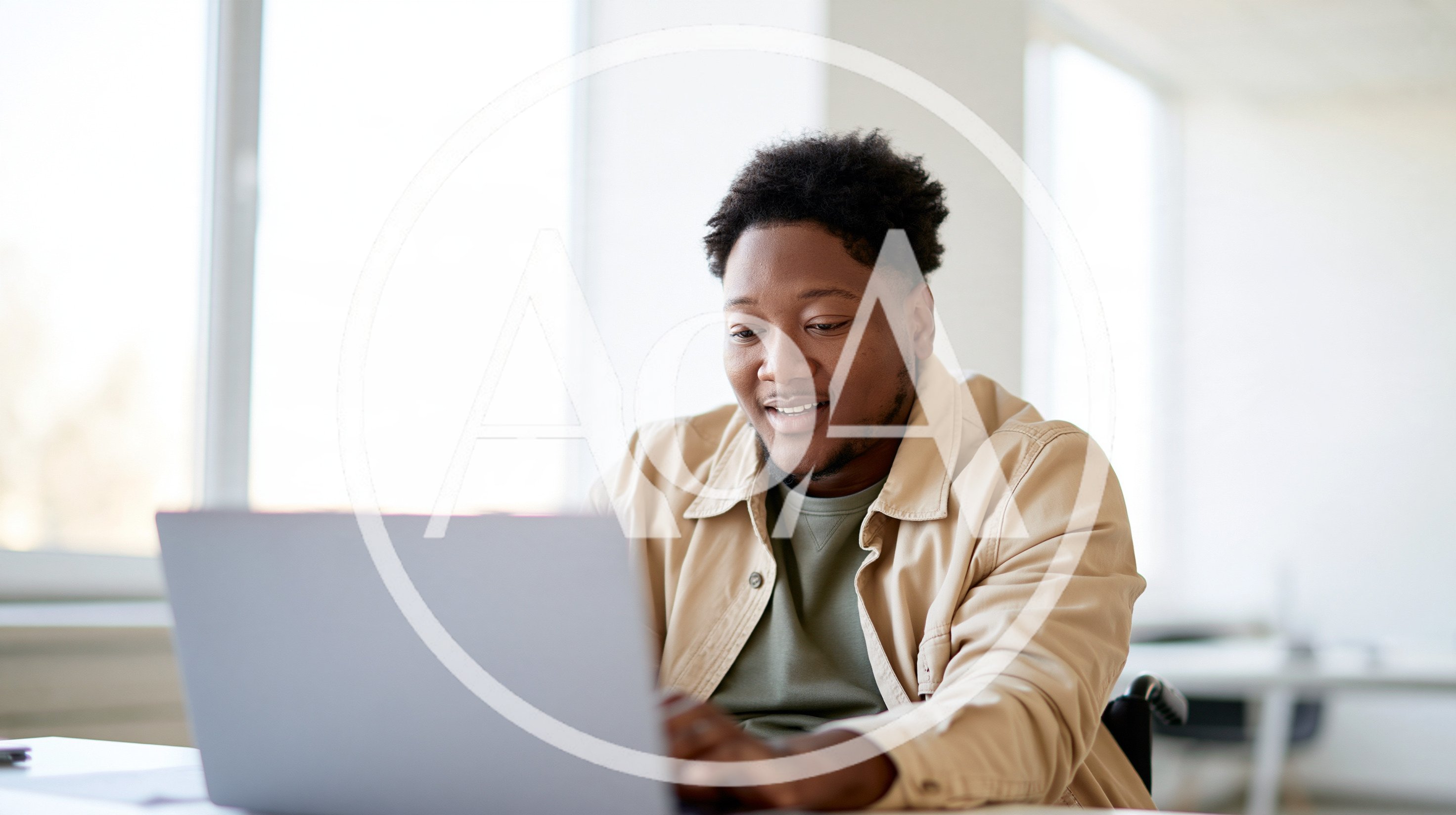 Young Black Man Working On Laptop In Bright Office