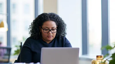 Professional Woman Working On Laptop In Modern Office