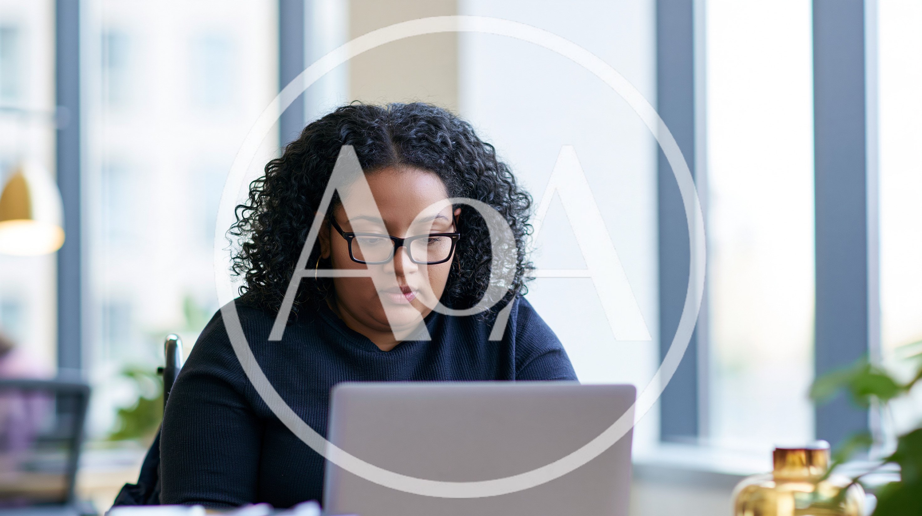 Professional Woman Working On Laptop In Modern Office
