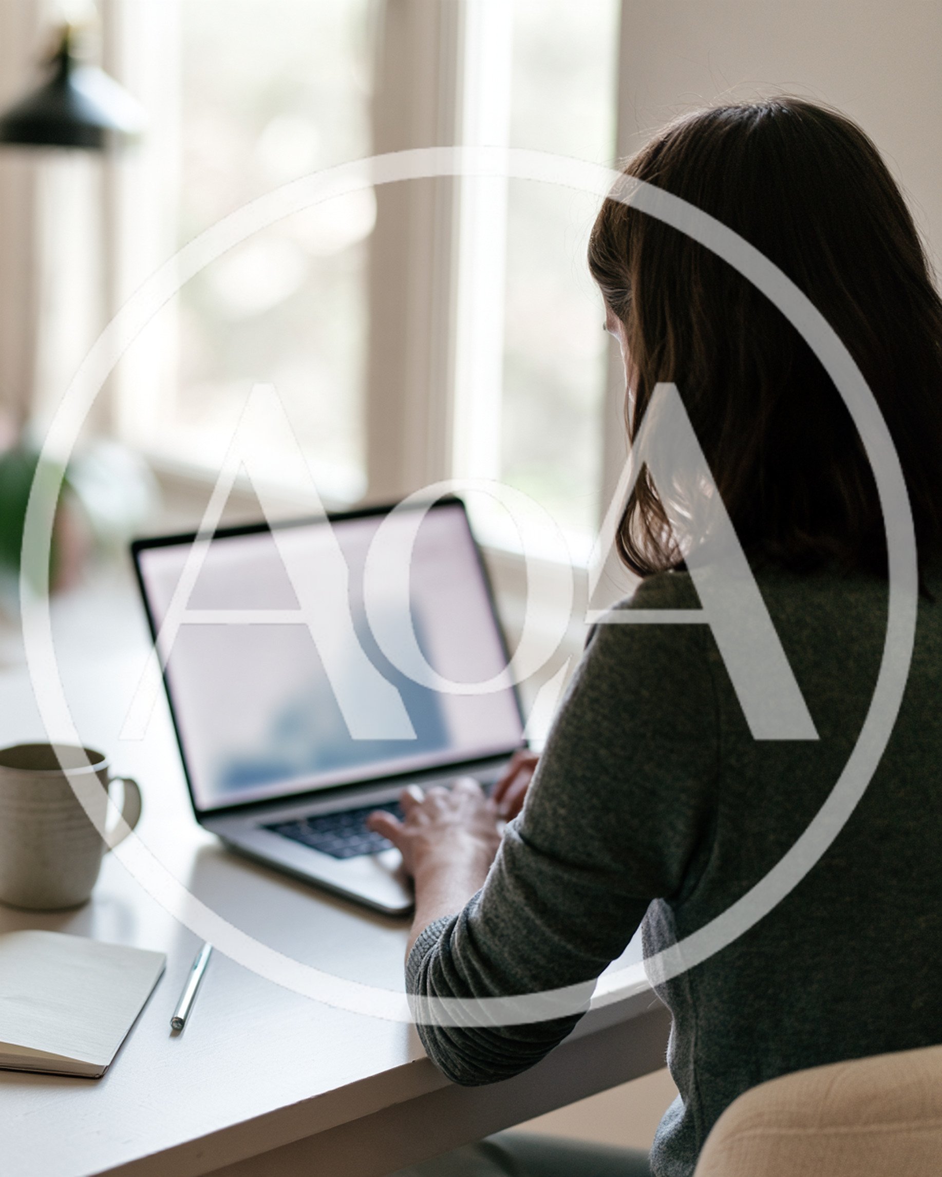 Woman Working On Laptop At Home Office Desk