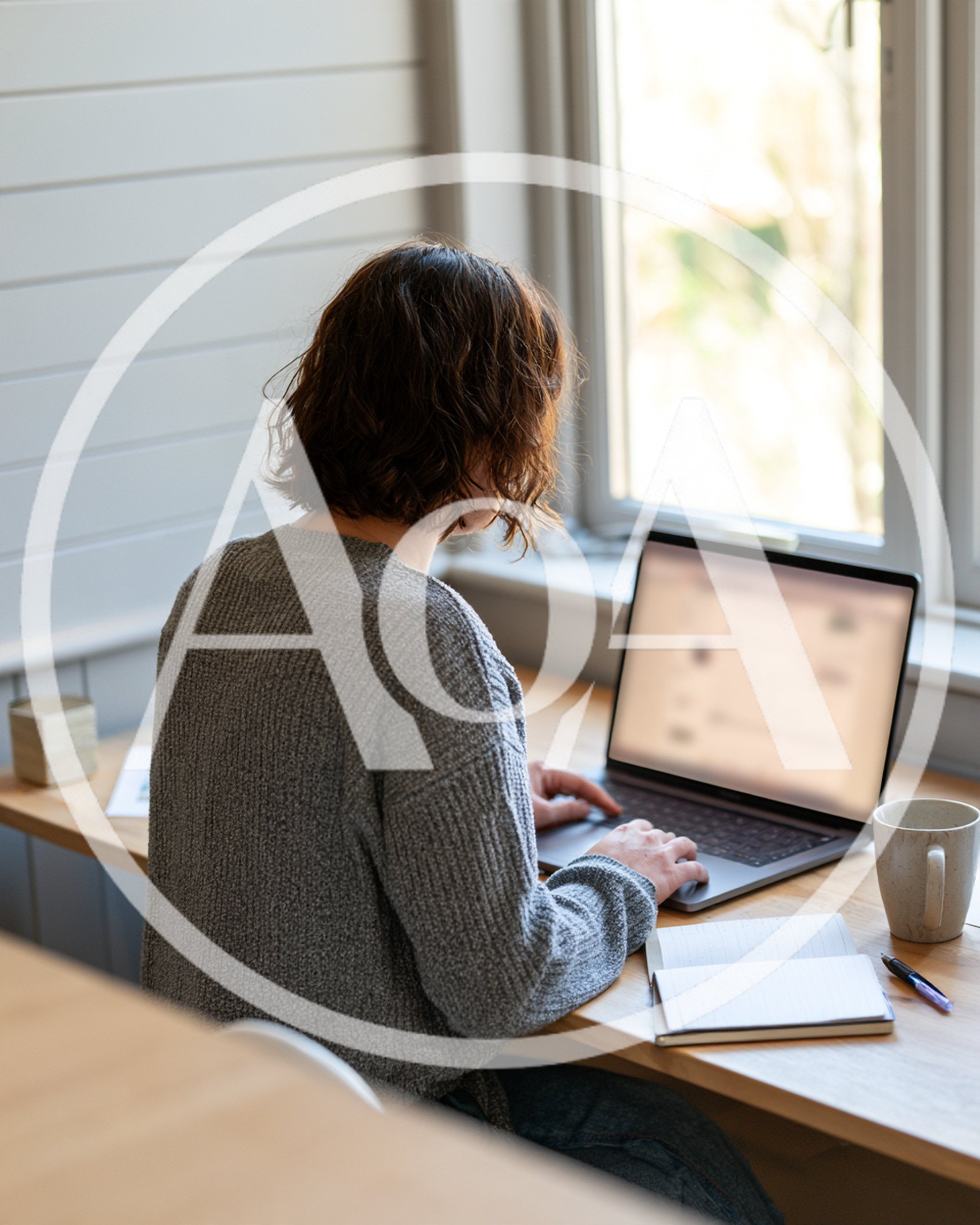 Woman Working On Laptop At Home Office Desk