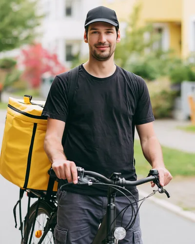 Delivery Courier With Yellow Backpack On Bicycle