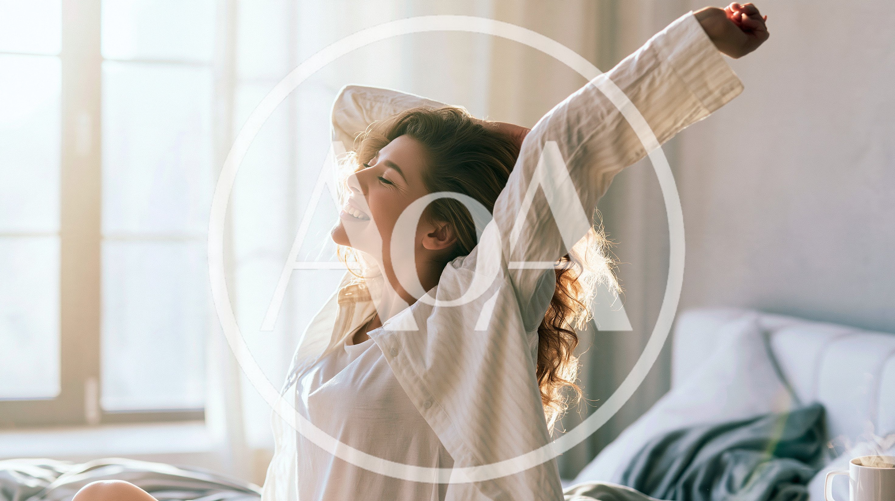 Young Woman Stretching In Bed During Morning Sunlight