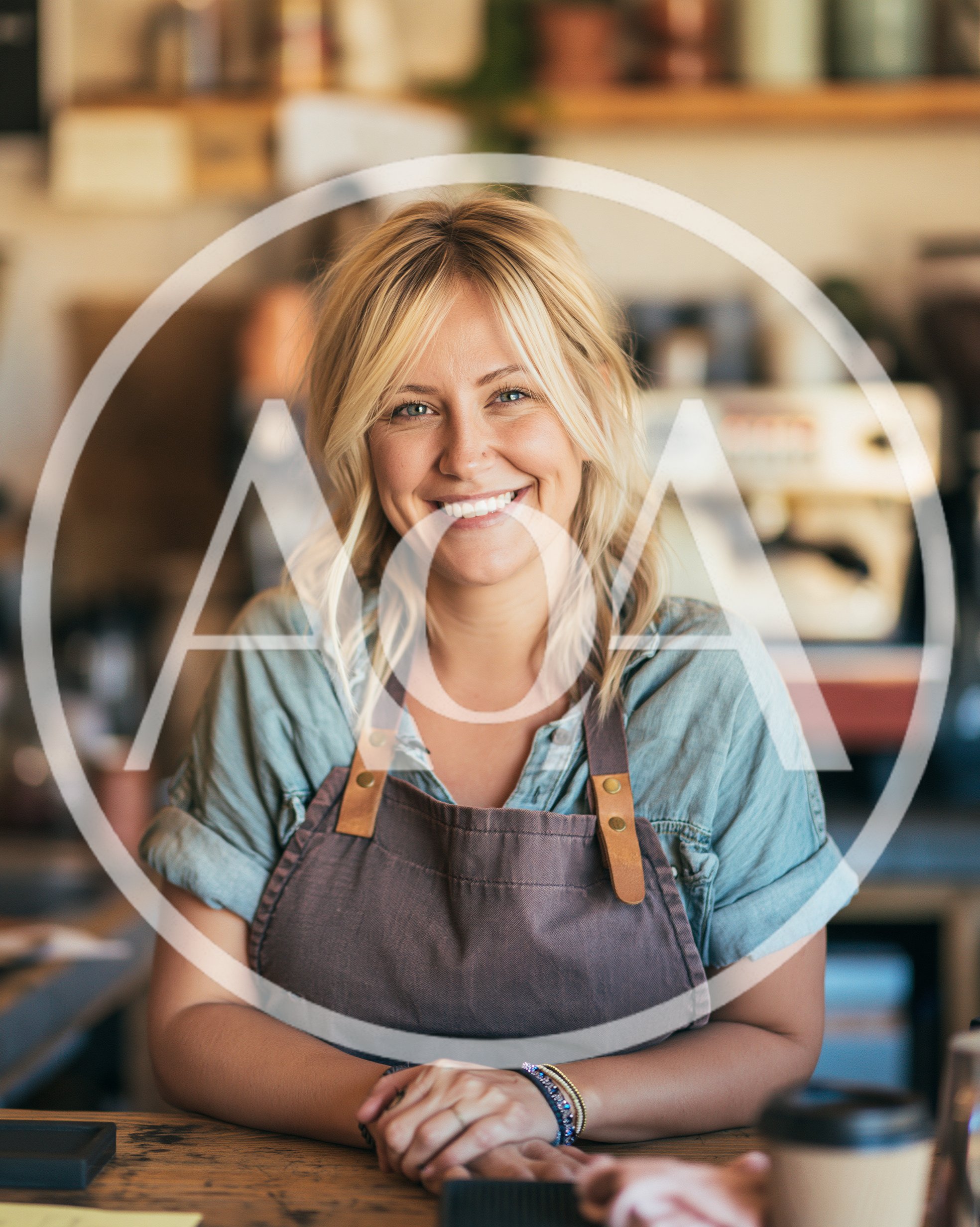 Smiling Female Barista Standing Behind A Coffee Shop Counter