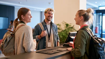 Young Travelers Checking In At Hotel Reception Desk