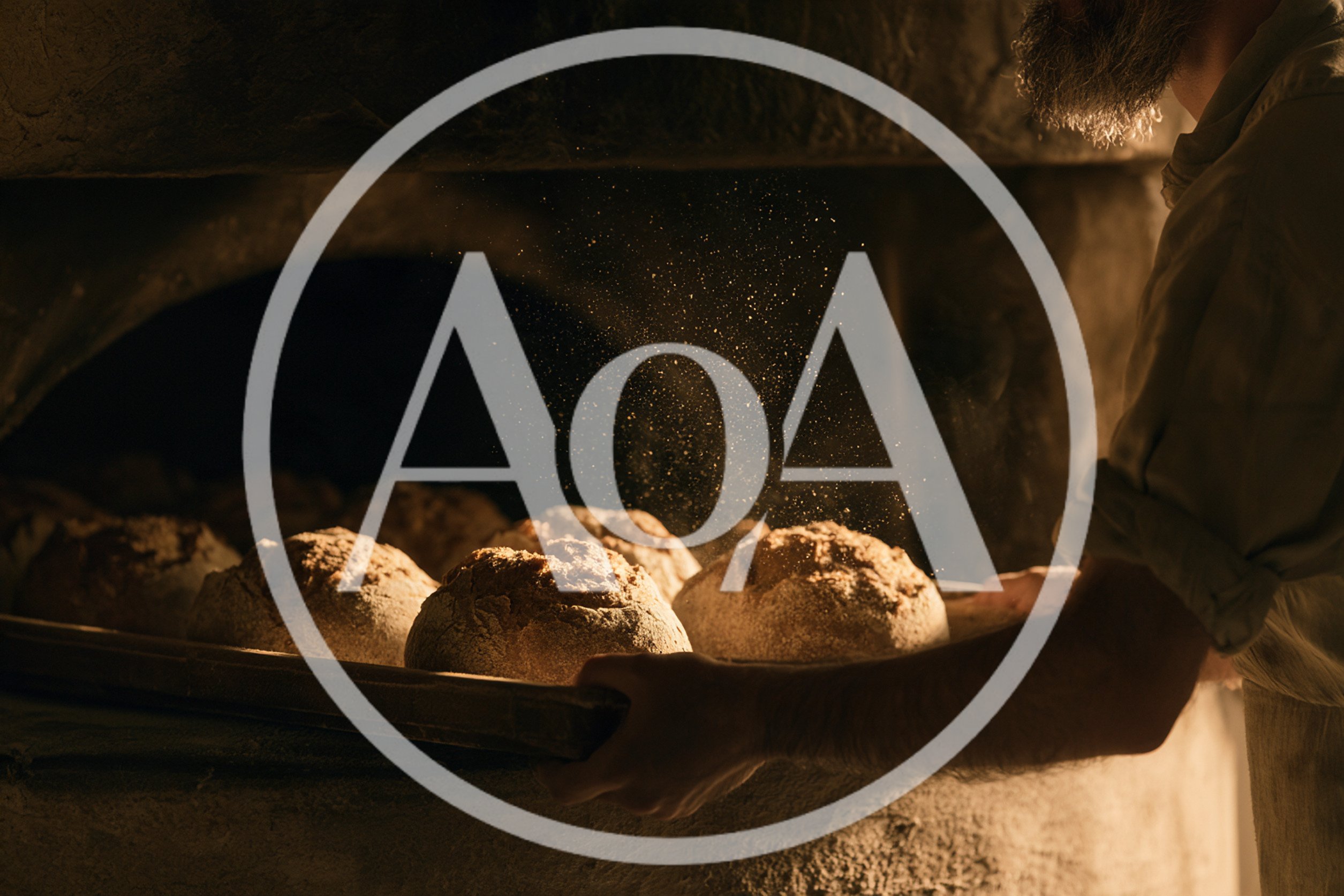 Artisan Baker Placing Fresh Bread Loaves Into Stone Oven