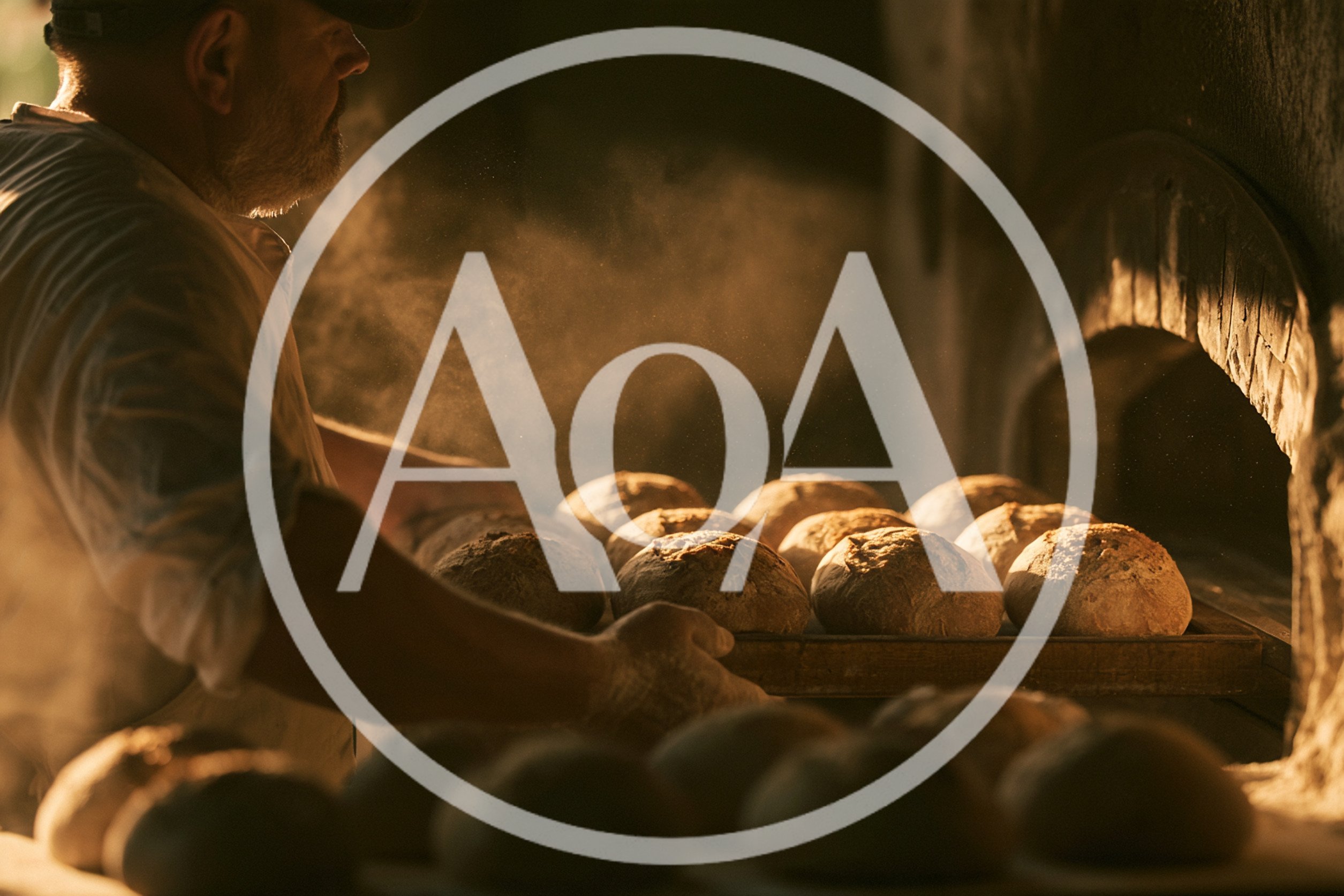 Artisan Baker Placing Fresh Bread Loaves Into Oven