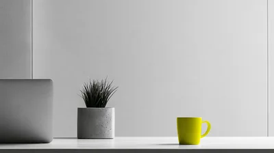 Minimalist Desk Setup With Laptop Plant And Yellow Mug