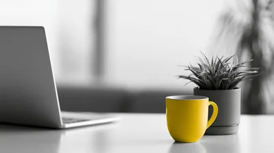 Yellow Coffee Mug And Laptop On Office Desk