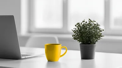 Laptop And Yellow Coffee Mug On Office Desk