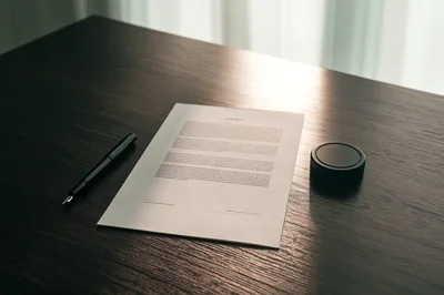 Fountain Pen and Contract on Dark Wooden Desk
