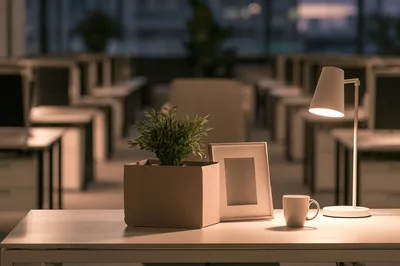Personal Belongings In A Cardboard Box On Office Desk