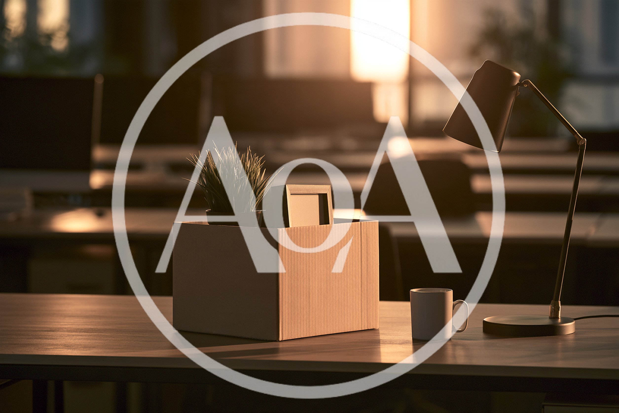 Cardboard Box With Personal Belongings On Office Desk