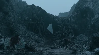 Ruined Wooden Mine Entrance In A Rocky Mountain Pass