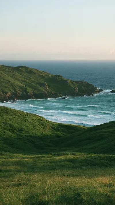 Rolling Green Hills Overlooking A Coastal Bay