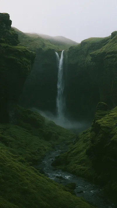 Kvernufoss Waterfall Cascading Down Mossy Icelandic Canyon