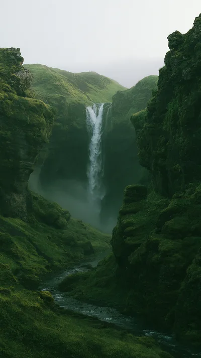 Kvernufoss Waterfall Flowing Through A Mossy Icelandic Canyon