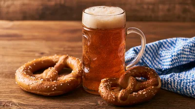 Bavarian Beer Mug With Pretzels On Wooden Table
