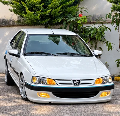 White Peugeot Pars Sedan Parked Outdoors