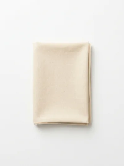 Folded Beige Cotton Fabric Napkin On White Background