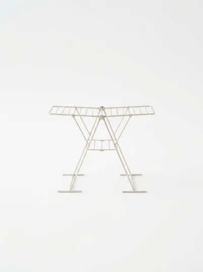 Minimalist Metal Clothes Drying Rack On White Background