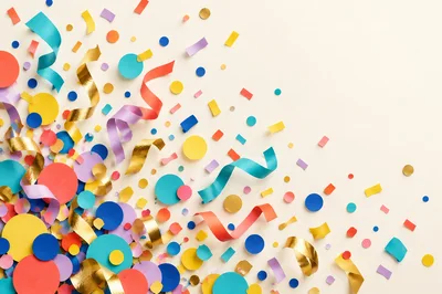 Colorful Party Confetti and Ribbons on Cream Background
