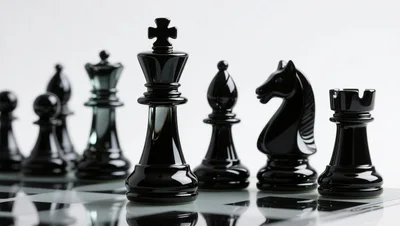 Black Chess Pieces Arranged On A Reflective Board