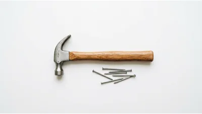 Claw Hammer And Metal Nails On White Background