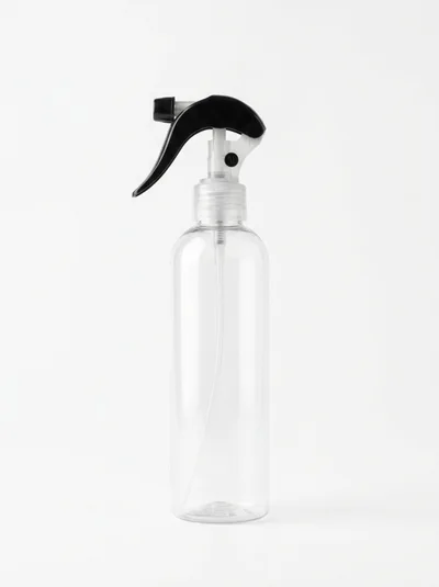 Empty Clear Plastic Spray Bottle On White Background