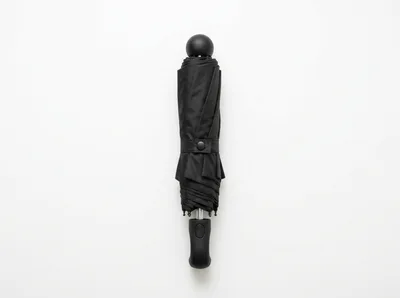 Closed Black Compact Umbrella On White Background