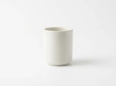 Minimalist White Ceramic Cup On White Background