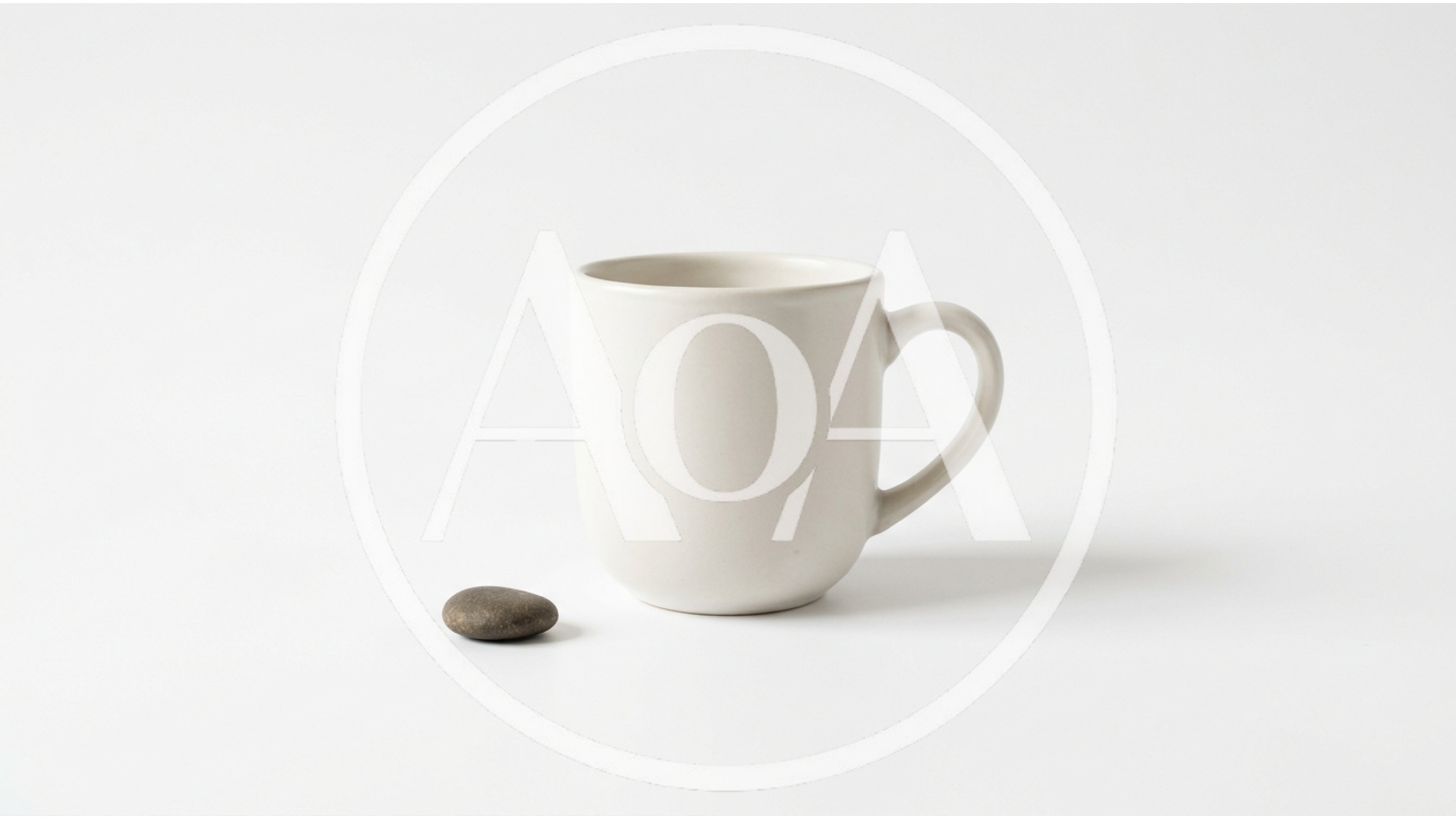Minimalist White Ceramic Mug And Small Stone