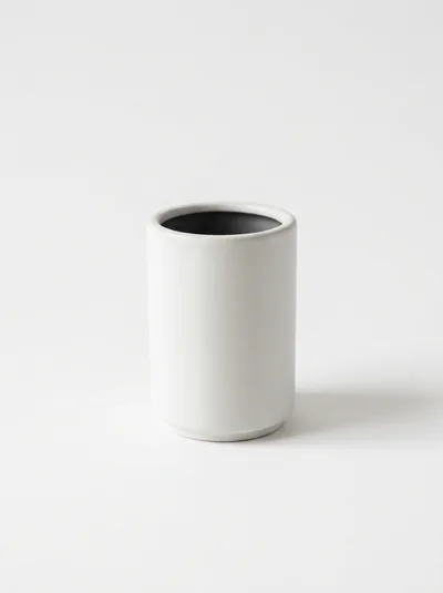 Minimalist White Ceramic Cup On White Background