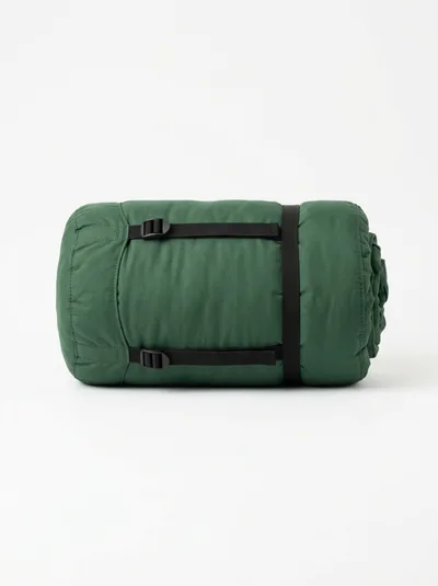 Rolled Green Sleeping Bag With Black Compression Straps