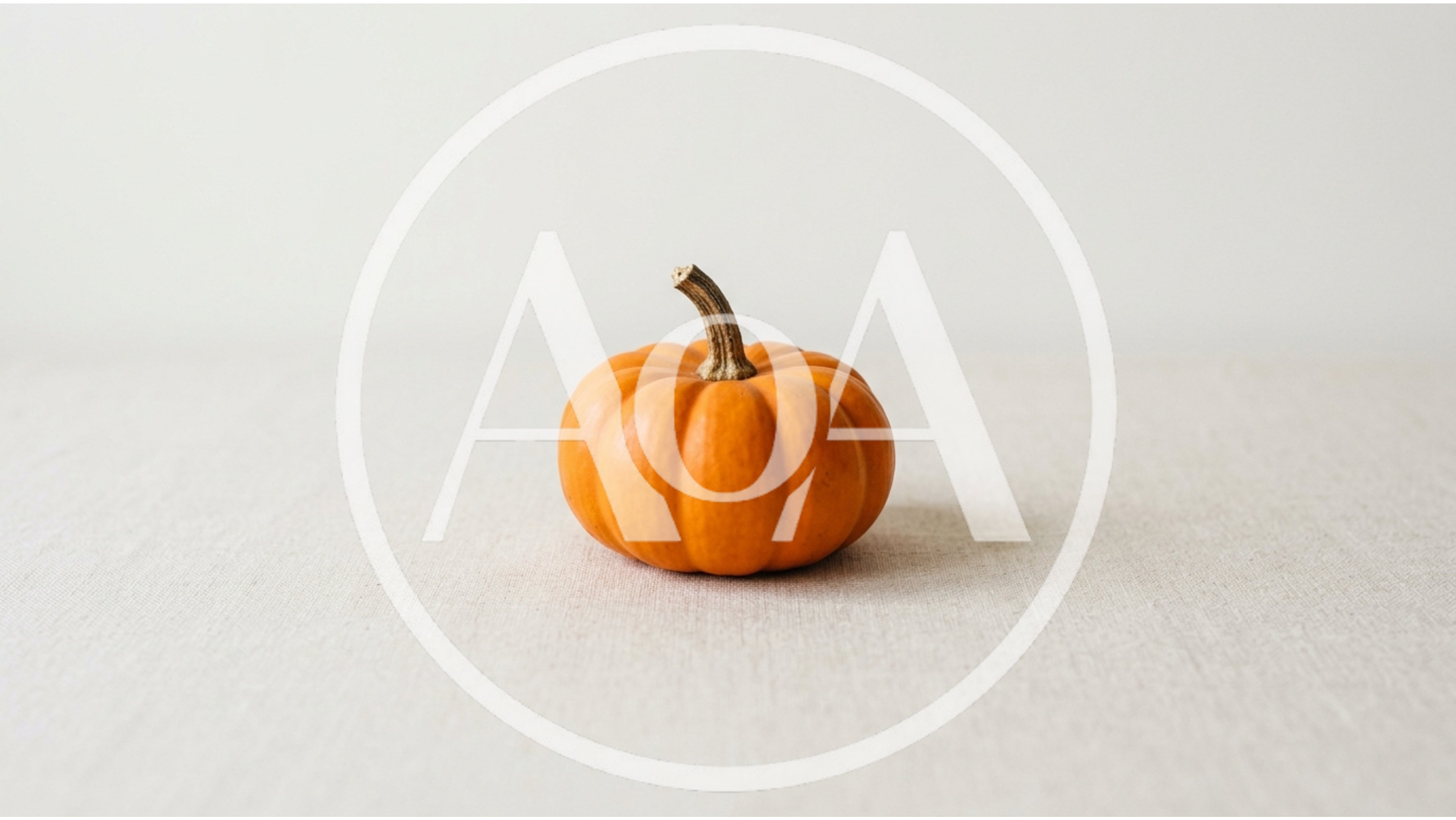 Small Orange Pumpkin On A Neutral Linen Background